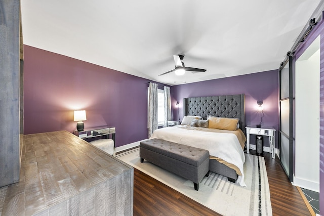 1609 Tabor St, Houston, TX 77009 - bedroom featuring baseboards, ceiling fan, a barn door, and wood finished floors