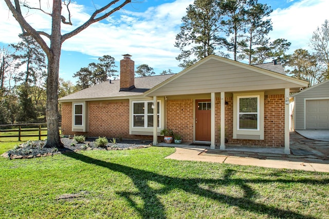 16507 Burklin Ln, Magnolia, TX 77355 - single story home with fence, a front lawn, brick siding, a garage, and a chimney
