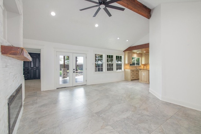unfurnished living room with a glass covered fireplace, beamed ceiling, recessed lighting, french doors, and a ceiling fan
