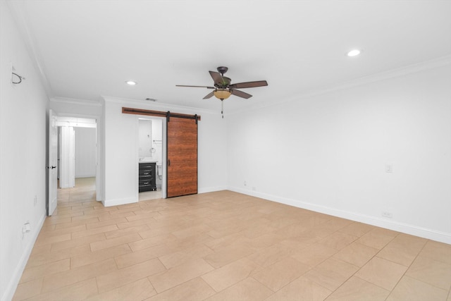 interior space with baseboards, ornamental molding, recessed lighting, and a barn door