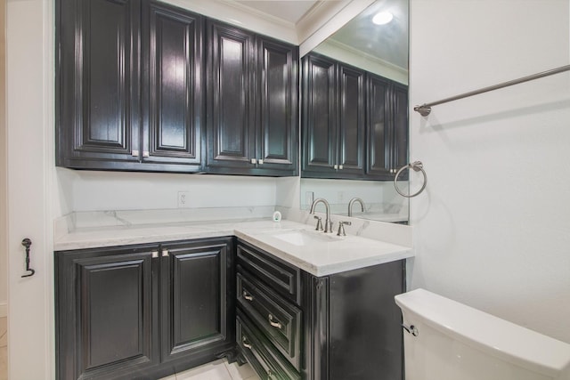 bathroom with crown molding, toilet, and a sink