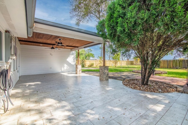view of patio / terrace with a fenced backyard, a carport, and ceiling fan