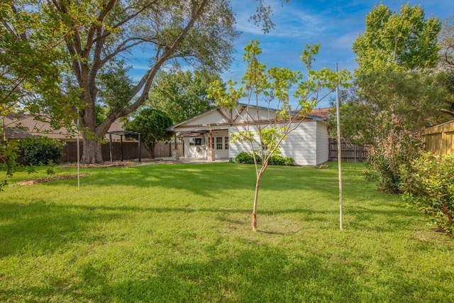 back of house featuring a lawn, a fenced backyard, and a patio area