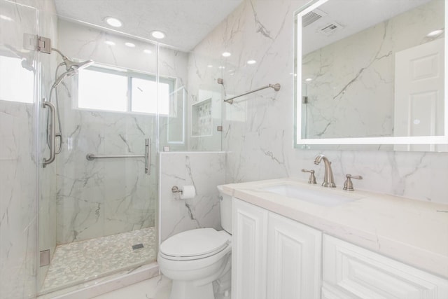 full bathroom with vanity, marble finish floor, toilet, tile walls, and a marble finish shower