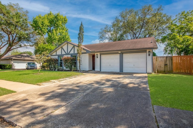view of front of home featuring fence, a front yard, brick siding, concrete driveway, and an attached garage