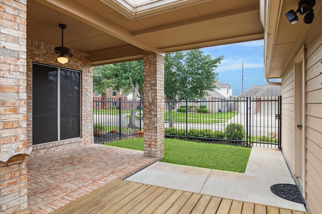 view of patio / terrace with ceiling fan and fence