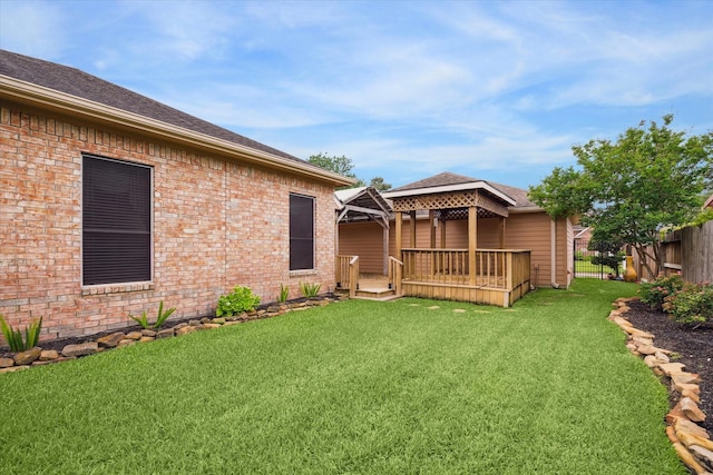 view of yard with a gazebo, fence, and a wooden deck