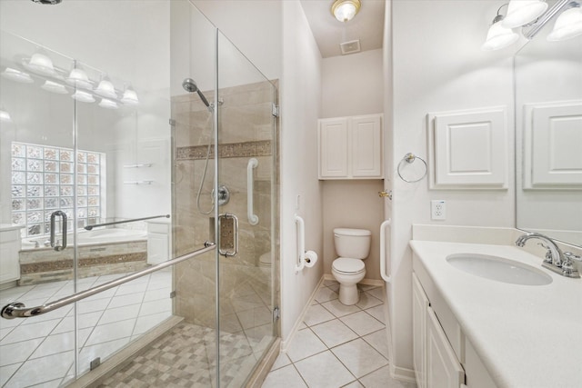 bathroom featuring tile patterned floors, a shower stall, vanity, and toilet