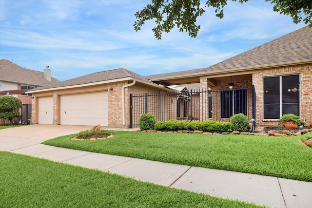 ranch-style house with a garage, fence, a front yard, and brick siding