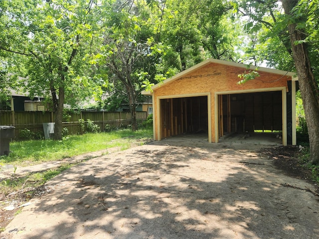 detached garage featuring fence