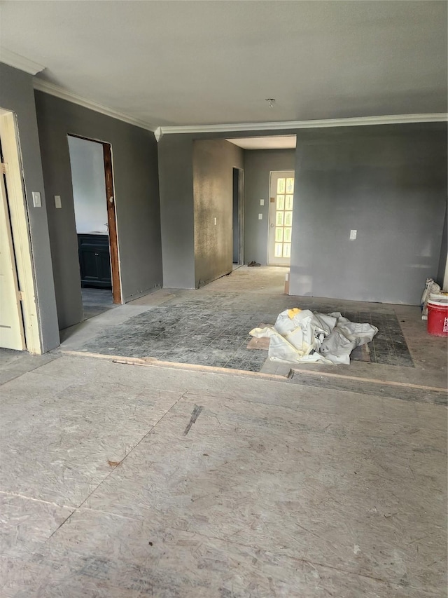 unfurnished living room with ornamental molding