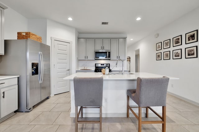 29823 Case Canyon Ln, Katy, TX 77494 - kitchen featuring gray cabinets, a sink, light countertops, light tile patterned floors, and stainless steel appliances