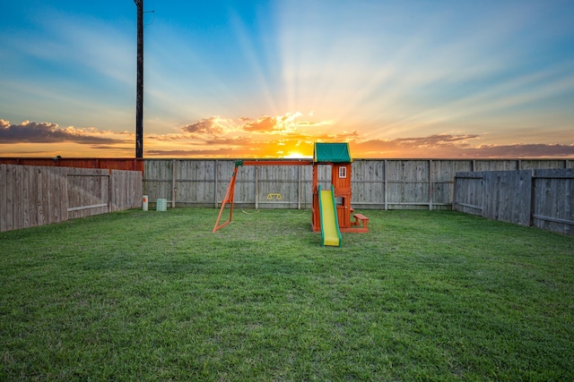 29823 Case Canyon Ln, Katy, TX 77494 - yard at dusk featuring a fenced backyard and a playground
