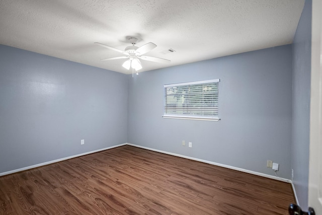 spare room featuring a ceiling fan, baseboards, a textured ceiling, and wood finished floors