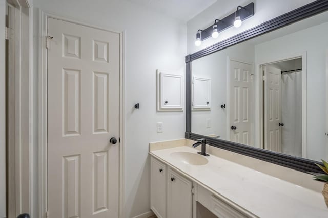 full bathroom with baseboards and vanity