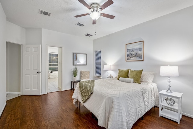 bedroom with visible vents, wood finished floors, and baseboards