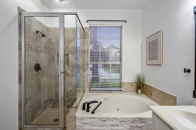 full bath with vanity, a jetted tub, and a stall shower