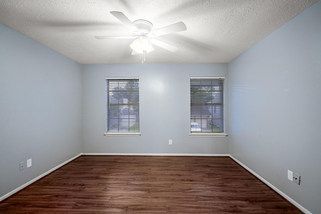 empty room featuring ceiling fan, a textured ceiling, baseboards, and wood finished floors