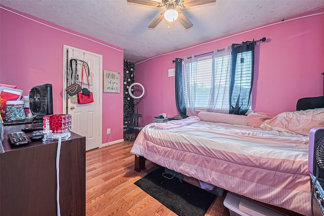 10834 Glenora Dr, Houston, TX 77065 - bedroom featuring light wood-type flooring, a ceiling fan, and a textured ceiling