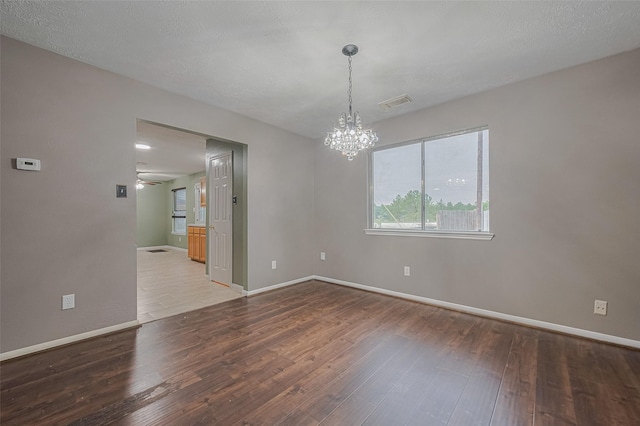 10834 Glenora Dr, Houston, TX 77065 - unfurnished room with wood finished floors, a chandelier, and a ceiling fan