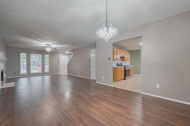 10834 Glenora Dr, Houston, TX 77065 - unfurnished living room with wood finished floors, a fireplace, a chandelier, a ceiling fan, and a textured ceiling