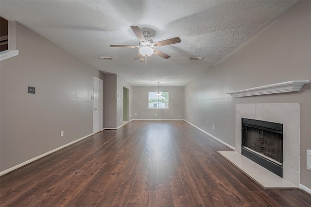 10834 Glenora Dr, Houston, TX 77065 - unfurnished living room with a ceiling fan, dark wood finished floors, a tiled fireplace, and a textured ceiling