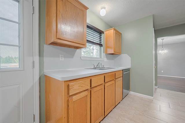 10834 Glenora Dr, Houston, TX 77065 - kitchen featuring dishwasher, light countertops, and a chandelier