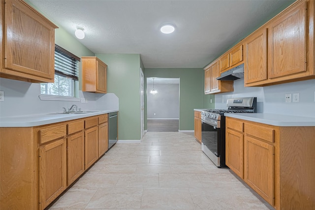 10834 Glenora Dr, Houston, TX 77065 - kitchen with stainless steel appliances, under cabinet range hood, light countertops, and light tile patterned flooring