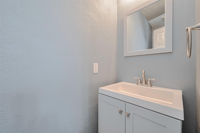 10834 Glenora Dr, Houston, TX 77065 - bathroom featuring vanity and a textured wall