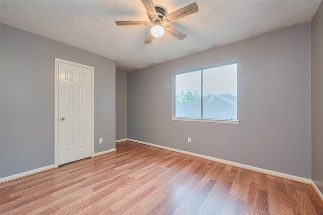 10834 Glenora Dr, Houston, TX 77065 - unfurnished room with a ceiling fan, light wood-style floors, and a textured ceiling