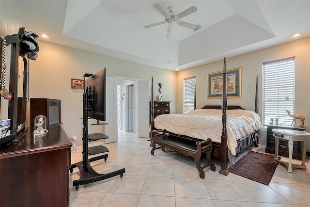 bedroom with a raised ceiling, recessed lighting, light tile patterned flooring, and visible vents