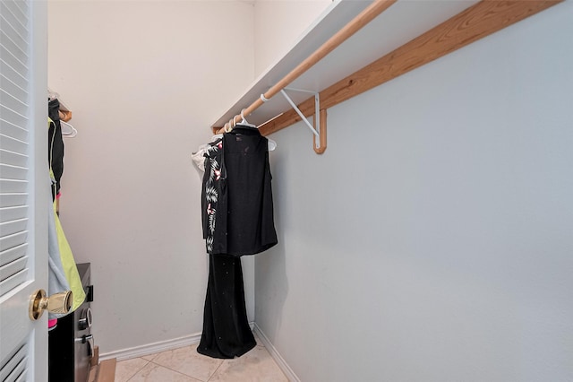 walk in closet with light tile patterned floors