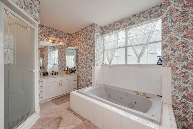 full bath with a tub with jets, vanity, tile patterned floors, and wallpapered walls