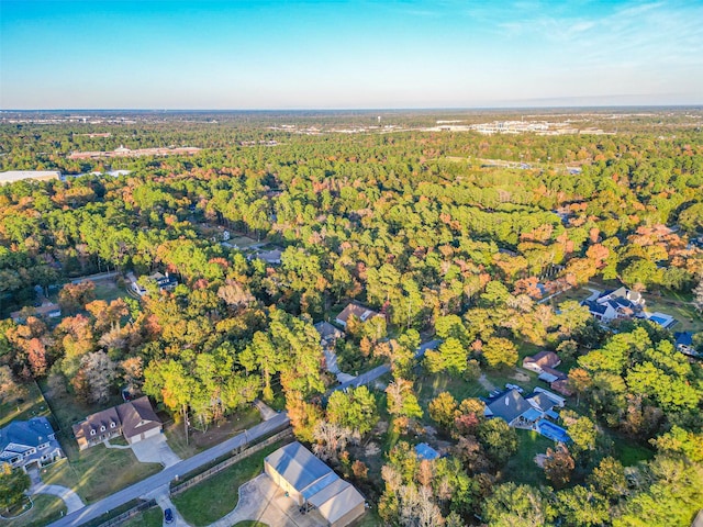 birds eye view of property with a wooded view