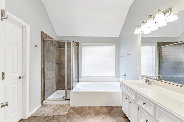 full bath with vanity, tile patterned flooring, a bath, a shower stall, and vaulted ceiling