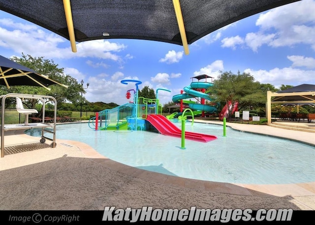 community playground with a water play area and a community pool