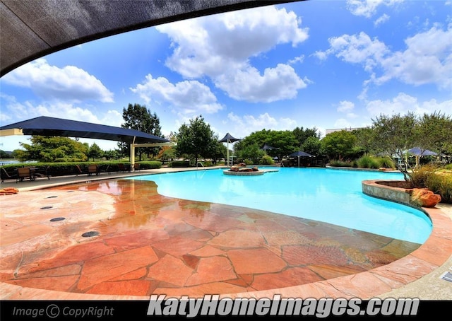 community pool featuring a patio area