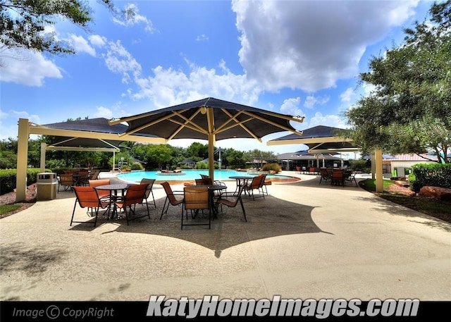 view of patio / terrace featuring a community pool and outdoor dining space