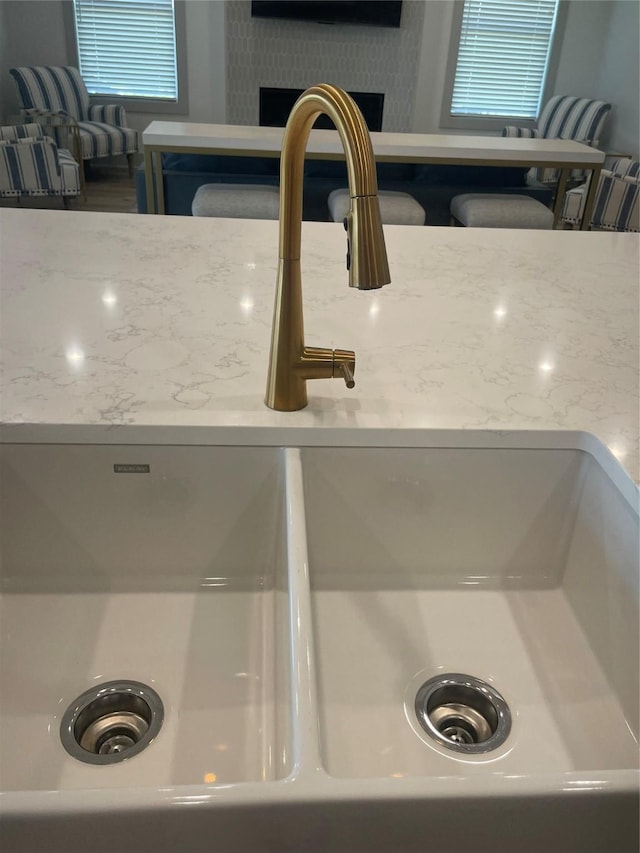 room details with light stone counters and a sink