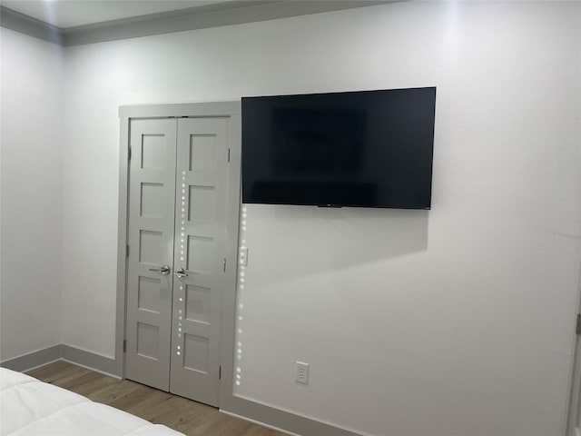 unfurnished bedroom with baseboards and wood finished floors