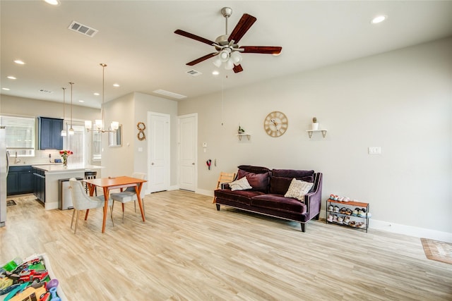 7709 Rainbow Close Ln, Houston, TX 77055 - living room featuring recessed lighting, baseboards, light wood-style flooring, and ceiling fan with notable chandelier