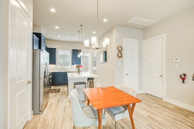 7709 Rainbow Close Ln, Houston, TX 77055 - dining space featuring visible vents, light wood finished floors, and a notable chandelier