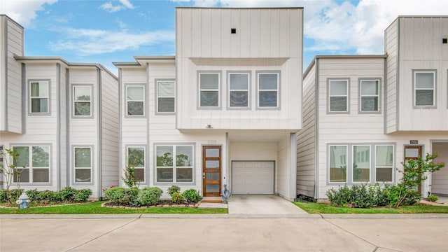 7709 Rainbow Close Ln, Houston, TX 77055 - view of property featuring a garage, board and batten siding, and driveway