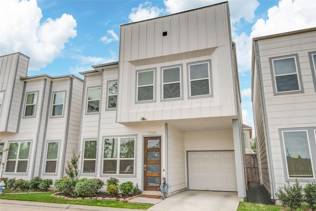 7709 Rainbow Close Ln, Houston, TX 77055 - townhome / multi-family property featuring a garage, board and batten siding, and driveway