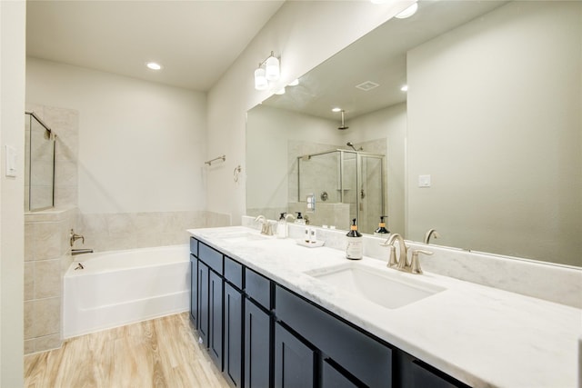 7709 Rainbow Close Ln, Houston, TX 77055 - bathroom featuring a sink, double vanity, a shower stall, and a garden tub