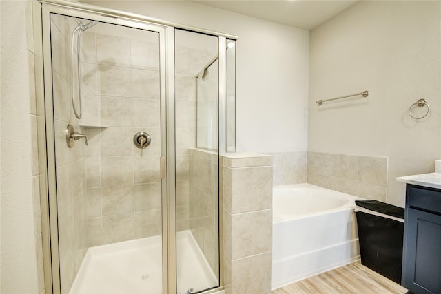 7709 Rainbow Close Ln, Houston, TX 77055 - bathroom featuring vanity, a garden tub, and a stall shower