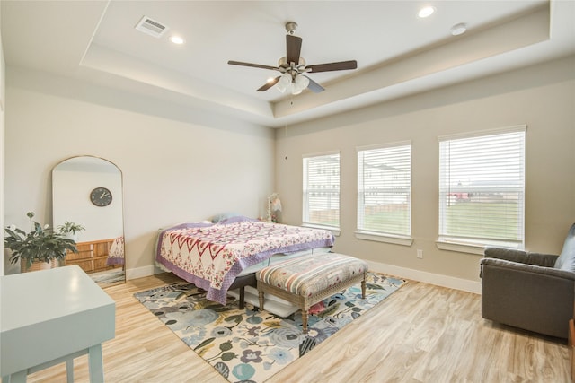 7709 Rainbow Close Ln, Houston, TX 77055 - bedroom featuring visible vents, wood finished floors, baseboards, recessed lighting, and a tray ceiling