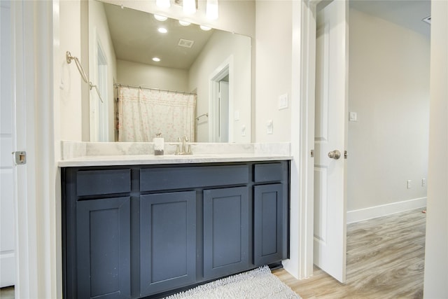 7709 Rainbow Close Ln, Houston, TX 77055 - bathroom featuring vanity, recessed lighting, baseboards, wood finished floors, and visible vents