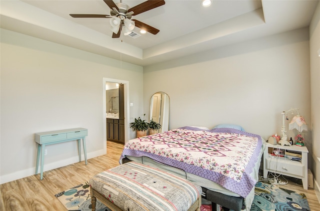 7709 Rainbow Close Ln, Houston, TX 77055 - bedroom with light wood-style floors, baseboards, a tray ceiling, and visible vents