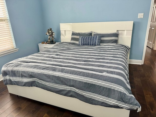 bedroom with baseboards and hardwood / wood-style floors
